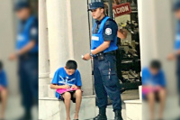 Imagen conmovedora: un policía ayuda a un nene a estudiar en la calle